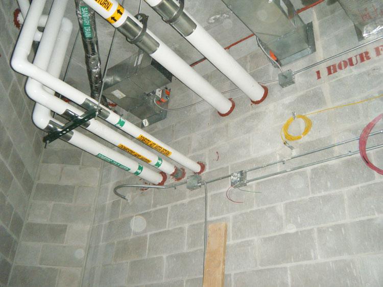 1-hour fire-rated wall assembly photographed in the field — drywall and steel-stud construction, taken during a plan-review walkthrough by Miller Brown