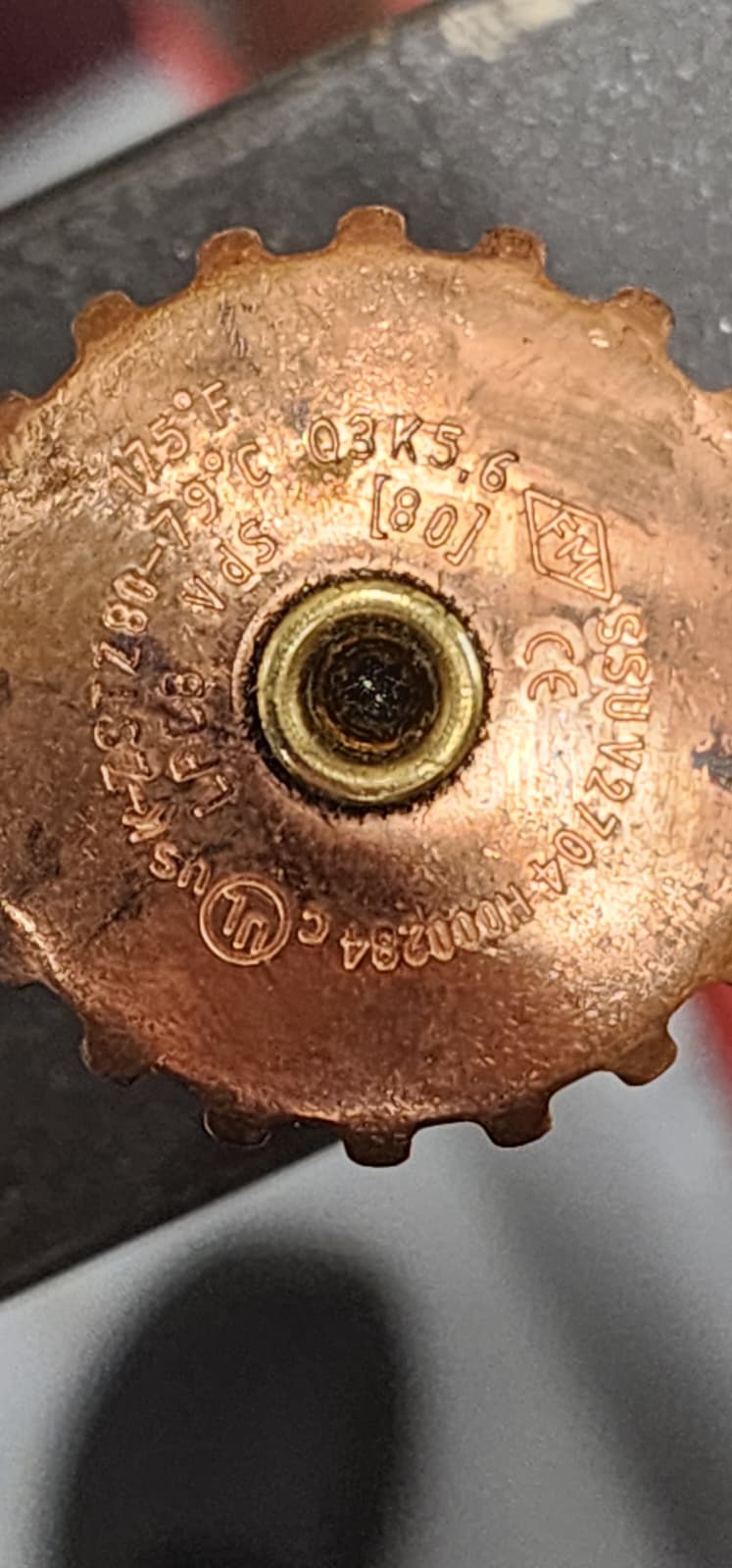 Close-up of an upright sprinkler deflector stamped 175°F / 79°C, K-factor K5.6 / K80, SIN beginning Q3, and the approval marks VdS, CE, FM and c-UL-us
