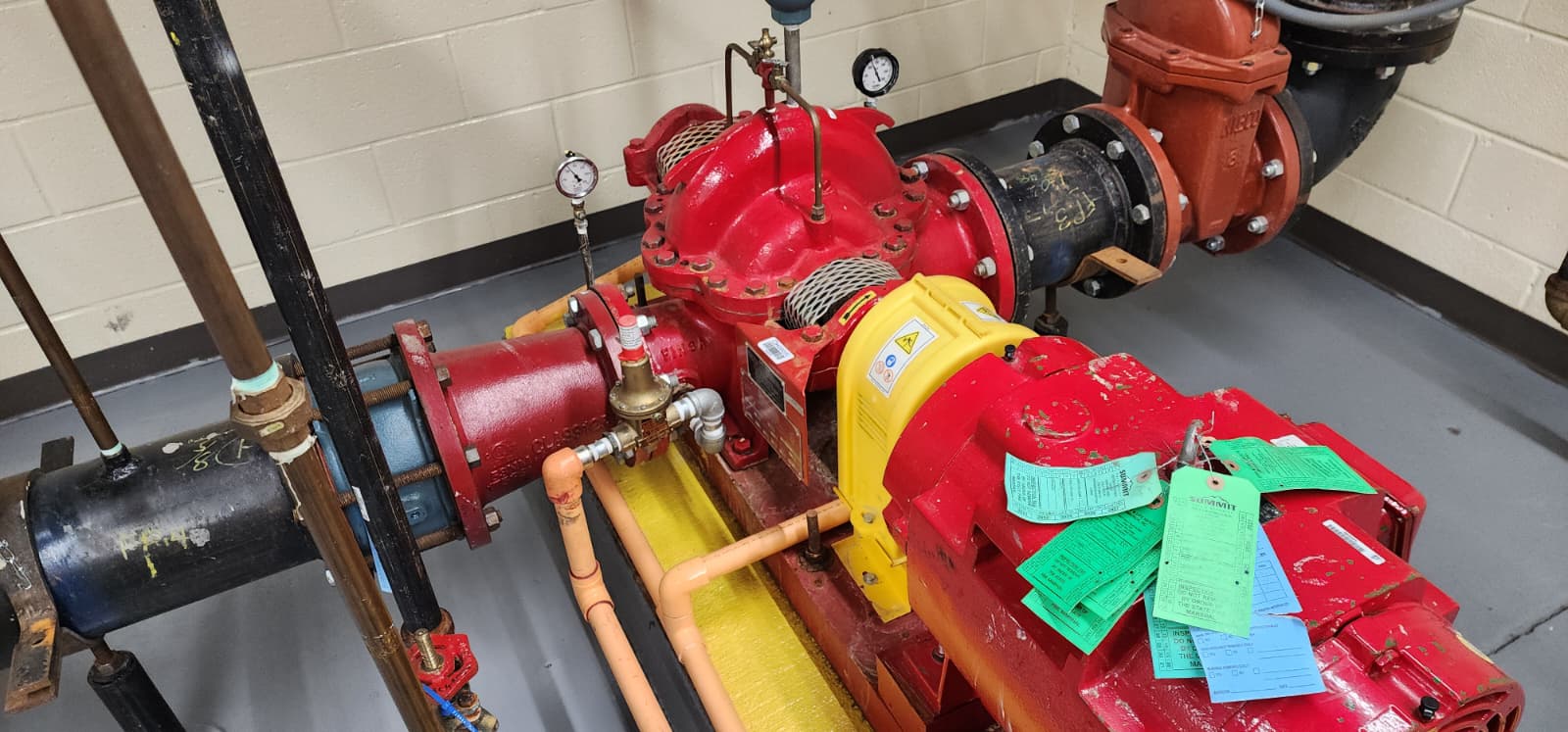 Horizontal split-case fire pump with electric motor driver — Summit pump with ITM inspection tags visible