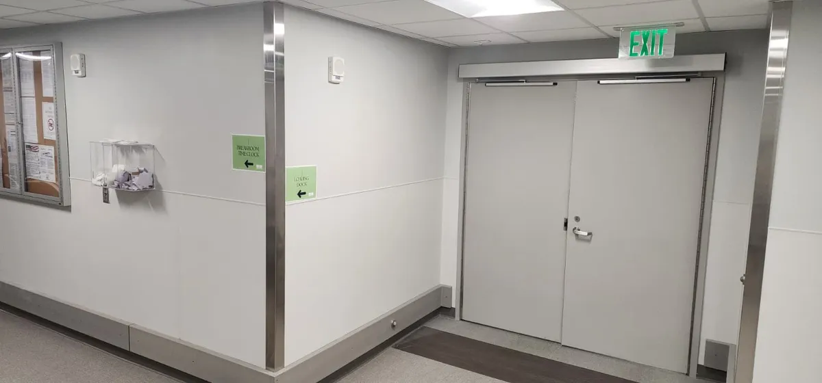 A corridor exit door fitted with access control hardware